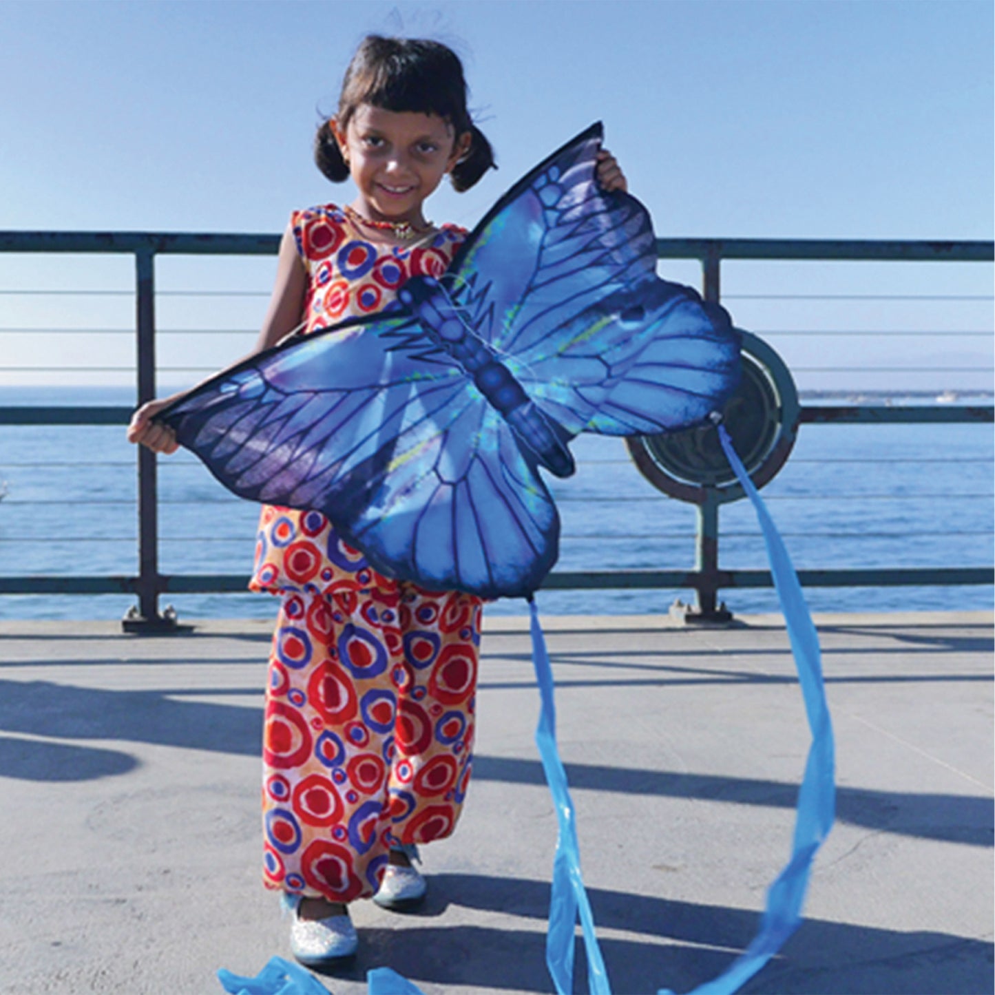 girl holding butterfly kite