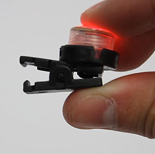 A photo of a WindNSun UFO Mini Light being squeezed between the index finger and the thumb to release the clip