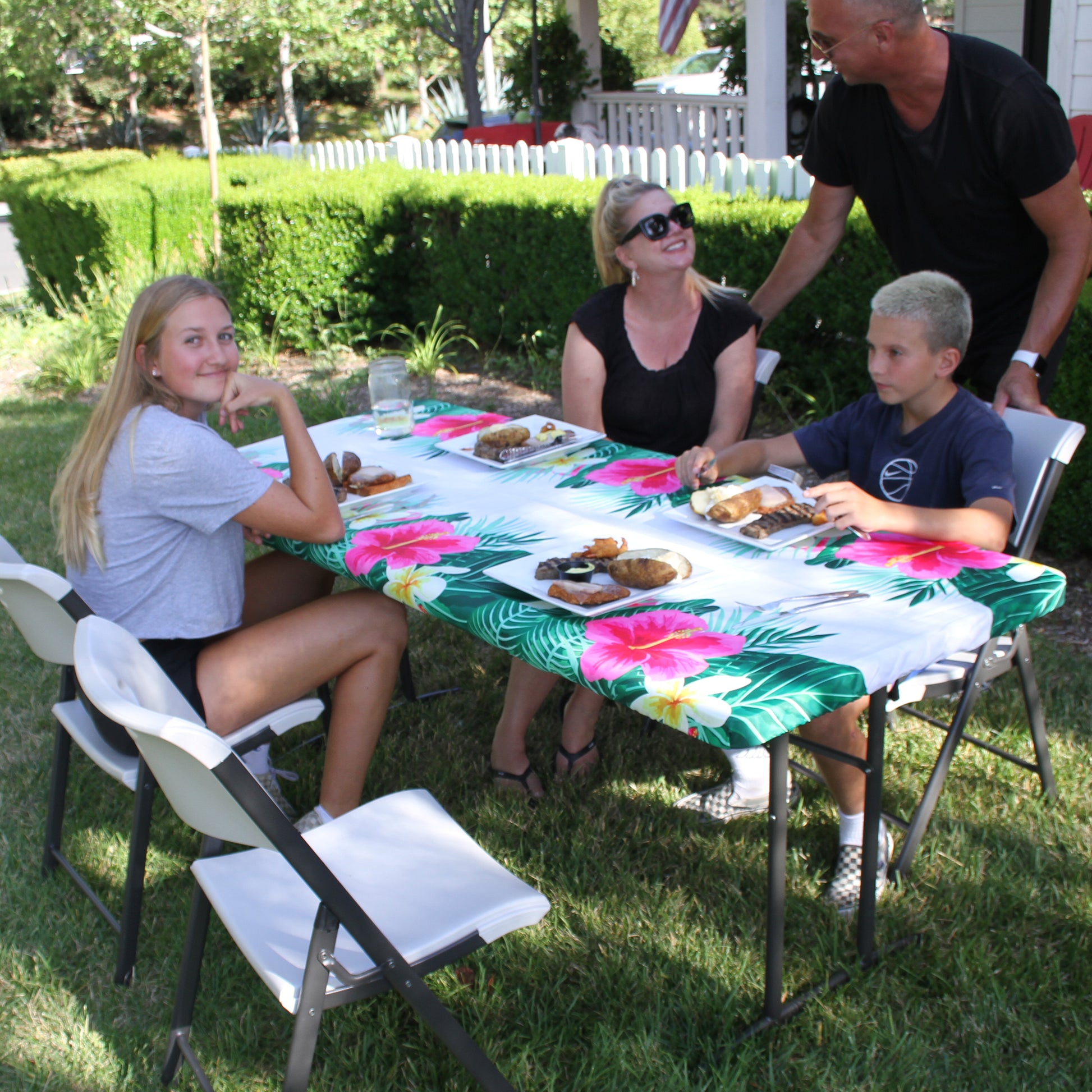 TableCloth PLUS 72" Fitted Polyester Tablecloth for 6' Folding Tables being used by a family of four