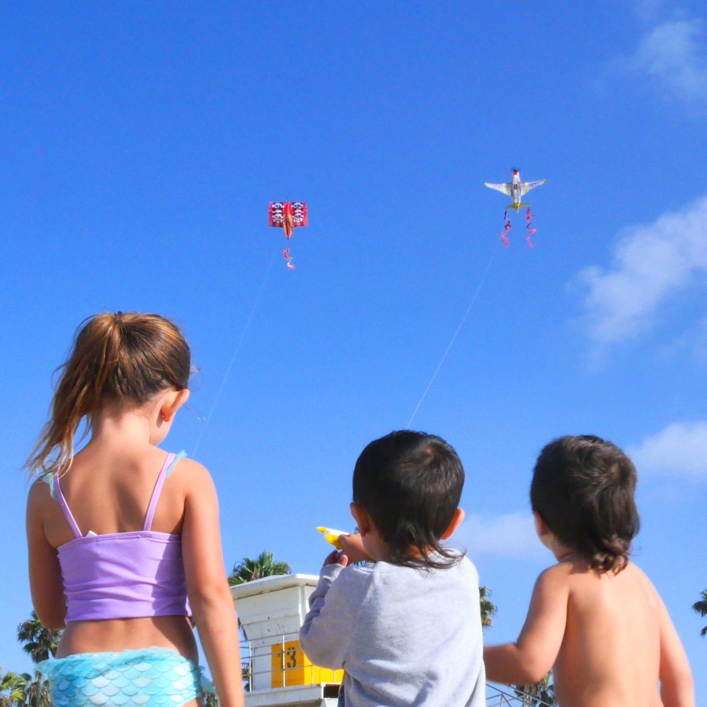 kids flying kites on the beach