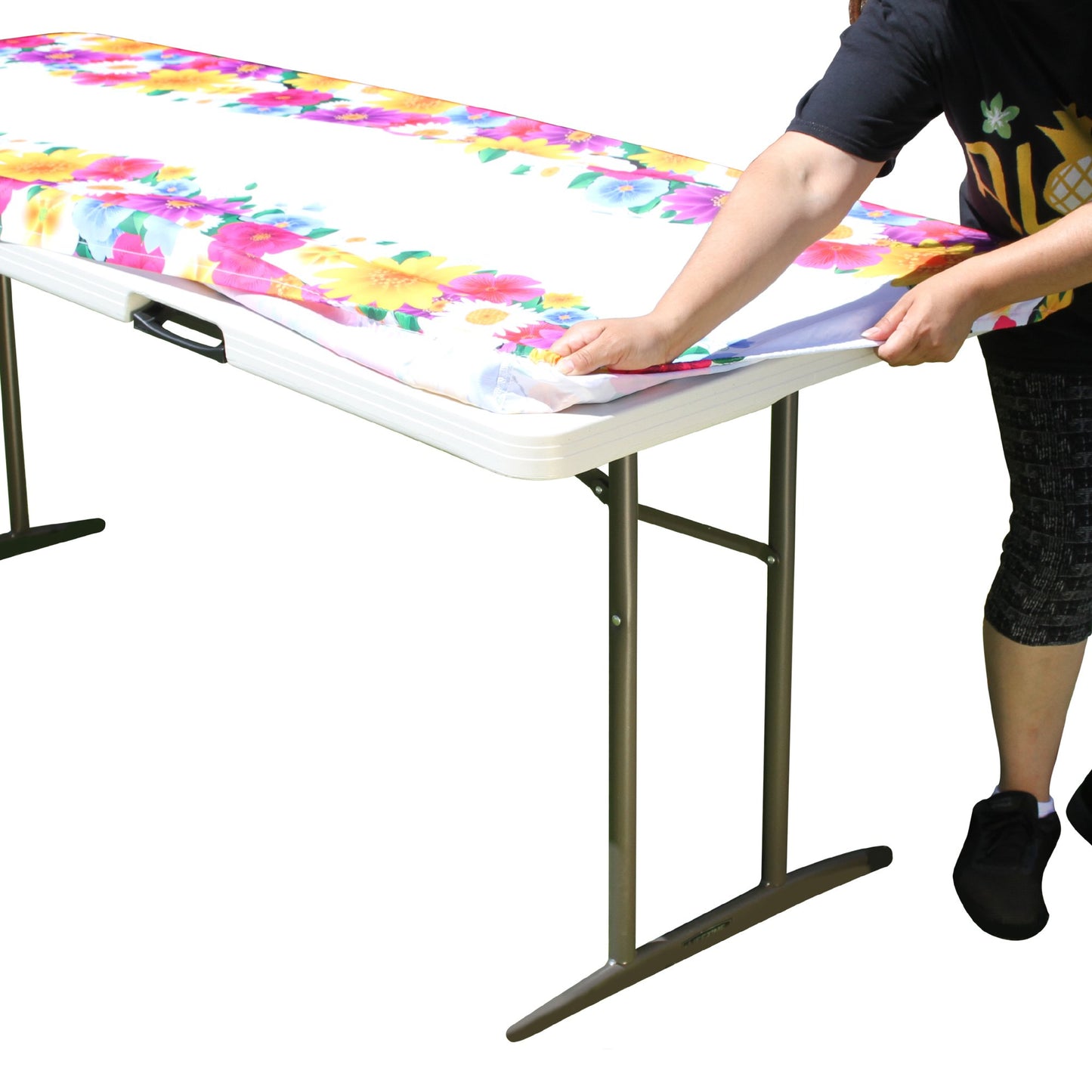 A person stretching TableCloth PLUS 72" Spring Fitted Polyester Tablecloth for 6' Folding Tables over a folding table