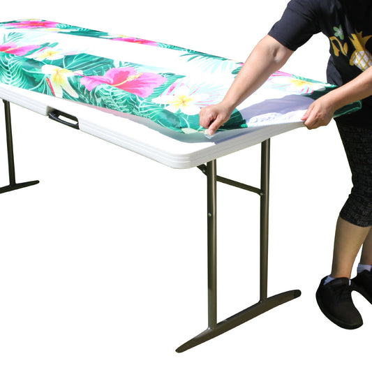 A person stretching TableCloth PLUS 72" Summer Fitted Polyester Tablecloth for 6' Folding Tables over a folding table