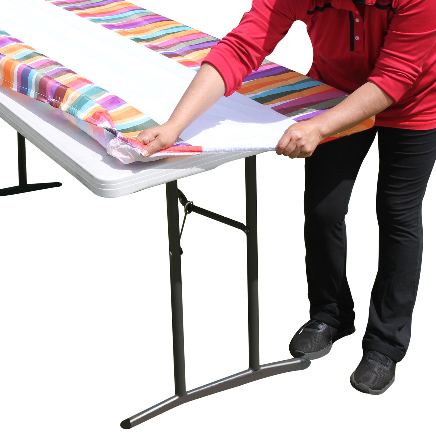 A person stretching TableCloth PLUS 96" Laces Fitted Polyester Tablecloth for 8' Folding Tables over a folding table
